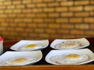 four white plates with three eggs on a tray at The Mastodon Valley Safari Resort in Udawalawe