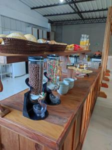 a wooden counter with vases and bowls on it at Pousada da Maira in Foz do Iguaçu