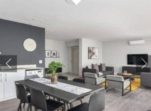 un salon avec une table et des chaises noires dans l'établissement Franschhoek - La Petit Village - Views, à Franschhoek