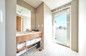 a bathroom with a sink and a mirror at Rakuten STAY Naha Yachimun Street in Naha +48 photos