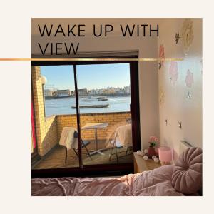 a sign that reads wake up with view in a bedroom at Perfect in the centre with view in London
