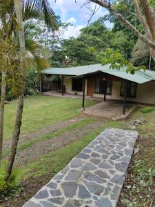 a house with a stone walkway in front of it at Natural paradise in Turrialba
