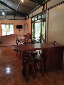 a room with a table and chairs and a couch at Natural paradise in Turrialba