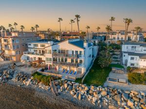 an aerial view of a building with a beach at Oceanfront Family Getaway - BBQ - Oceanfront Seating in Oceanside