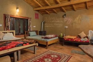 a room with two beds and a chalkboard on the wall at Zenoaks Homestay in Almora