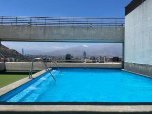 a large swimming pool with a view of the city at Atalaya Apartment Suite in Santiago