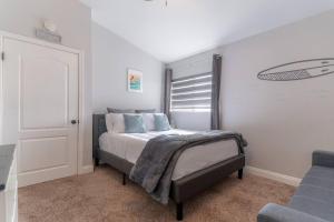 a bedroom with a bed with blue pillows at Ohana’s Home in Chula Vista