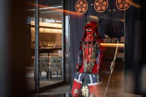 a mannequin in a red outfit in a store window at Noku Osaka in Osaka