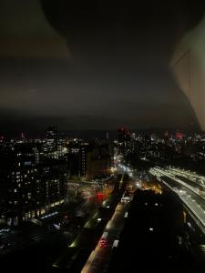 a city lit up at night with traffic at Luxurious Versace Apartment in London