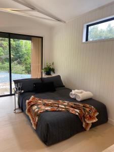 a bedroom with a large bed and a window at Private Guest House in Wongawallan
