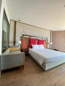 a bedroom with a large bed with red pillows at Luxury APEC MANDALA MŨI NÉ SG HAPPY HOUSE in Ấp Thiẹn Ái