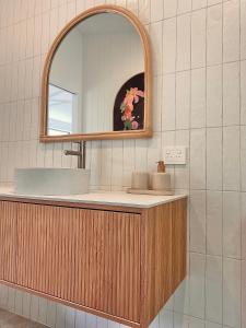 a bathroom with a sink and a mirror at Private Guest House in Wongawallan