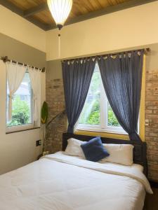 Un dormitorio con una cama grande con cortinas azules. en Lagom Home, en Hue