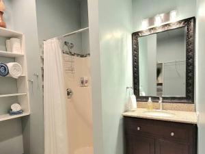 a bathroom with a shower and a sink and a mirror at Immaculate Home w/ Mtn and River Views! in East Wenatchee +18 photos