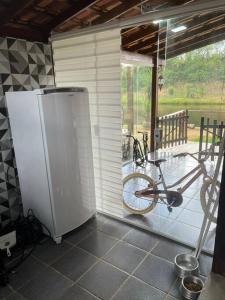 a bike parked in a room with a porch at Chalé aconchegante in Itu +21 photos