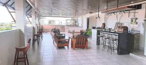 a room with chairs and a counter in a restaurant at Hotel Selva Dorada in Iquitos