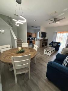 a dining room and living room with a table and a couch at Cozy Stylish Townhome in Davenport