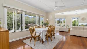 a dining room with a table and chairs at Kooringal Cottage - Home By The Sea in Woorim