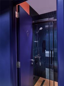 a bathroom with a shower with a purple door at Kepler Club Kuala Lumpur Airport - KLIA Transit Hotel Airside in Sepang