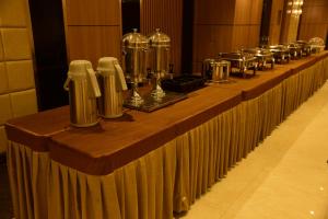 a long table with bottles and jars on it at Hotel Grand Serene, Mysore in Mysore