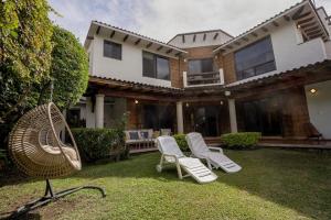 a group of chairs in the yard of a house at Cozy family house I Pool & Bar l Cuernavaca in Cuernavaca