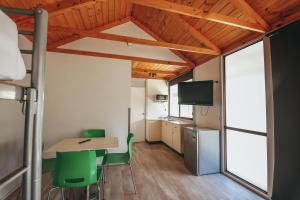 a small room with a table and green chairs at Eaglehawk Park Canberra in Canberra