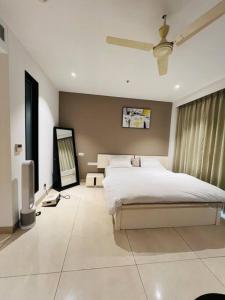 a bedroom with a bed and a television in it at Luxury Studios Key 4 in Gurgaon