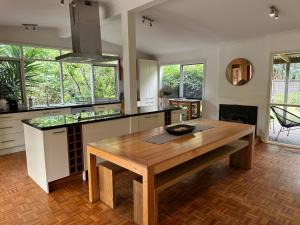 a kitchen with a wooden table in a room at Patsy's Gate - Red Hill South in Red Hill South