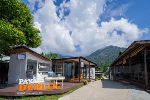 a group of buildings with mountains in the background at Paya Debloc Village in Tioman Island