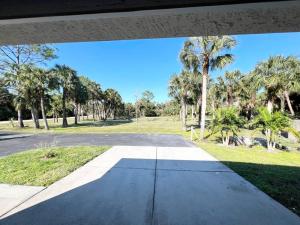 an empty street with palm trees in a park at Holiday Home in Naples. Long term welcome in Naples