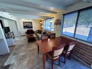 a living room with a table and chairs and a couch at One Bedroom Apartment at Rancho Rillito in Tucson