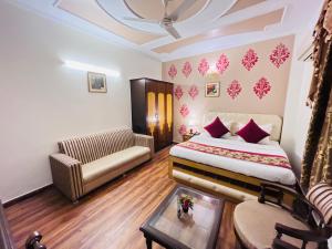 a hotel room with a bed and a couch at Paras Inn in New Delhi