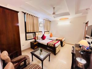 a hotel room with a bed and a table at Paras Inn in New Delhi