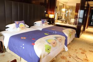 Llit o llits en una habitació de Estandon Hotel Guangzhou