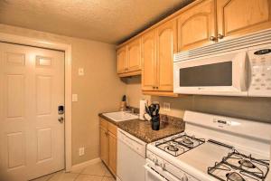 a kitchen with a white stove and a microwave at Palm Wave Stays - Central and Cozy Apt in West Palm Beach