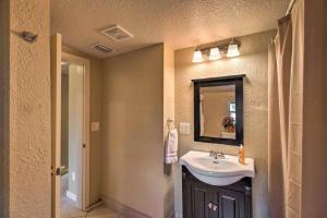 a bathroom with a sink and a mirror at Palm Wave Stays - Central and Cozy Apt in West Palm Beach