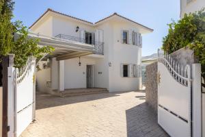a villa with a gate in front of a house at Accomoteleia Crystal Lagoon Villa in Protaras