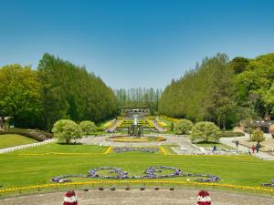 a view of a park with a fountain and trees at APA Hotel Sagamihara Hashimoto Ekimae in Sagamihara