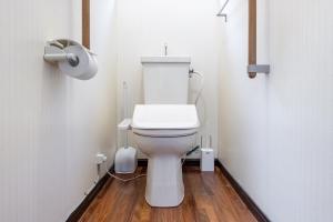 a bathroom with a white toilet in a stall at 神谷戸建 in Tokyo