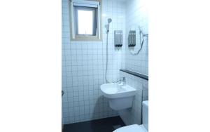 a bathroom with a toilet and a sink at 38th Street Guesthouse in Mokpo