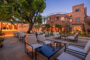 a patio with chairs and tables in front of a building at Zostel Jodhpur, Ratanada in Jodhpur