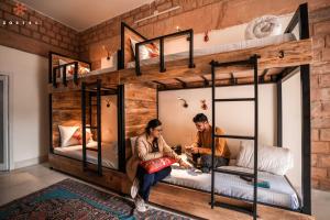 two people in a room with bunk beds at Zostel Jodhpur (Ratanada) in Jodhpur