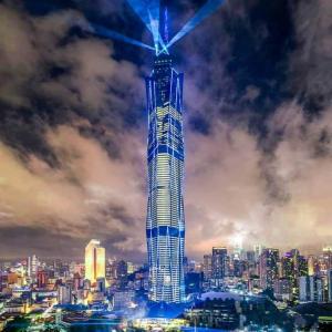 a tall building with blue lights on top of it at Opus Residences Kuala Lumpur by Luna in Kuala Lumpur