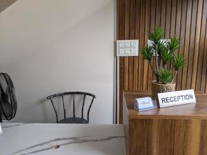 a bedroom with a bed and a desk with a registration sign at Ocean Blue Medical College in Kozhikode