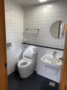a bathroom with a toilet and a sink at 38th Street Guesthouse in Mokpo