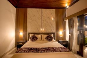 a bedroom with a bed with two pillows on it at Abasan Hill Hotel and Spa in Nusa Penida