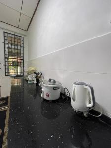 a room with a appliance on the floor of a room at THREE ROOMS WITH WIFI HOMESTAY D’RAZAK IN KUALA TERENGGANU in Kuala Terengganu