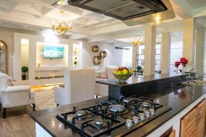 a kitchen with a stove and a living room at 41 Haven in Nairobi
