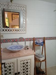 a bathroom with a sink and a mirror at Dar Baaziz 3 in Sousse