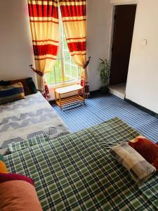 Säng eller sängar i ett rum på Niwasa House